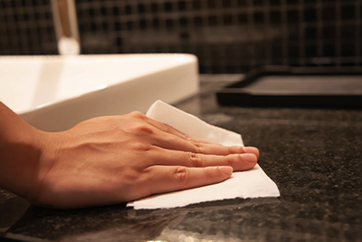 Hand wiping bathroom counter